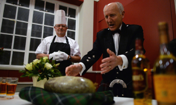 Hugh Farrell addresses the haggis at a Burns supper in the bard's birtplace of Alloway in Ayrshire.