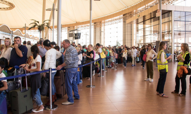 Tourists line up for luggage screening at the airport of Sharm el-Sheikh.