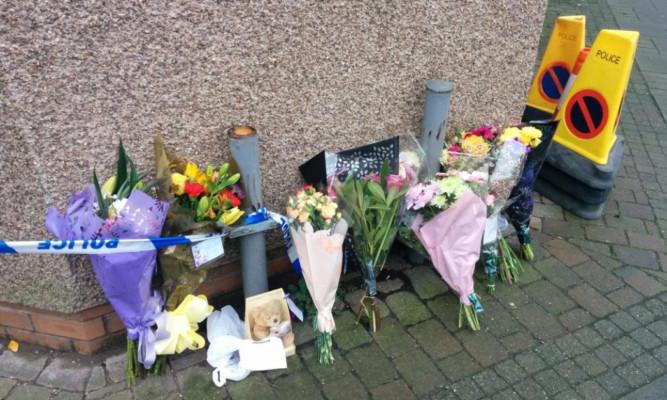 Flowers left at the scene of the police investigation in Montrose.