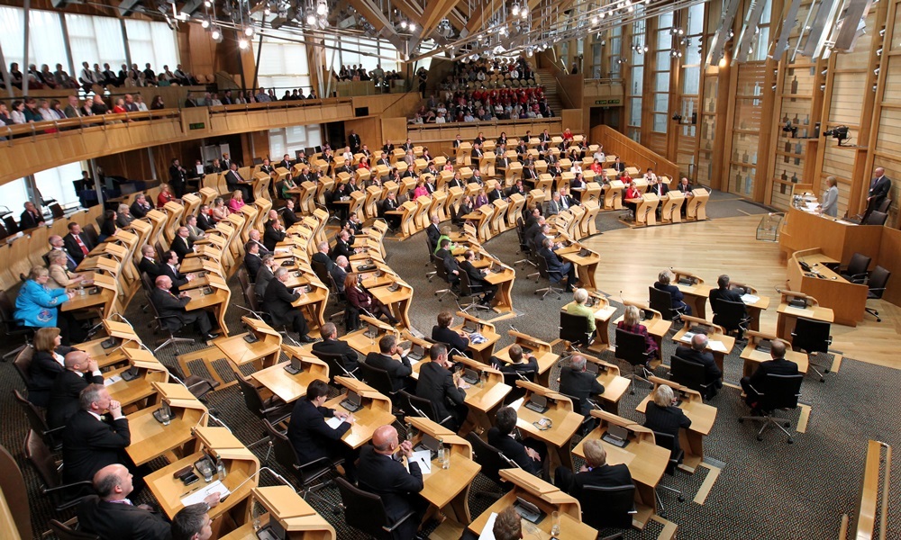 Newly elected MSP Tricia Marwick (far right) takes her position as the new Presiding Officer of the Scottish Parliament in Edinburgh as newly elected MSP's look on at a ceremony in the debating chamber.