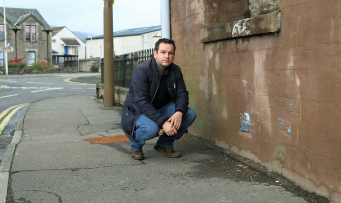 Community councillor Craig Finlay at the scene where a woman was badly injured.