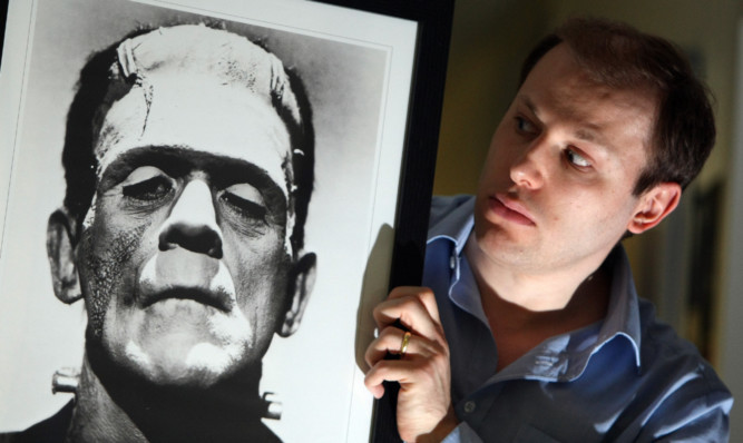 Dr Cook with a portait of the iconic monster.