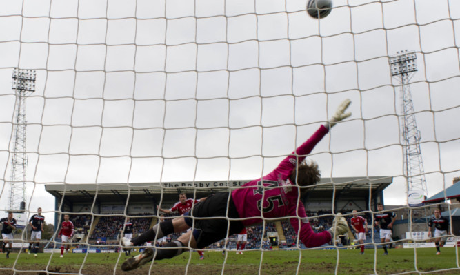 Steve Simonsen is unable to save Niall McGinn's penalty.