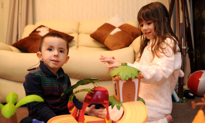 Oliver playing at home with sister Darcey.