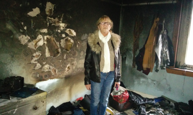 Marion Ferguson at the scene of her fire-ravaged house in Glencraig.