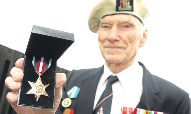 Kenneth Reith shows his Arctic Star Medal.
