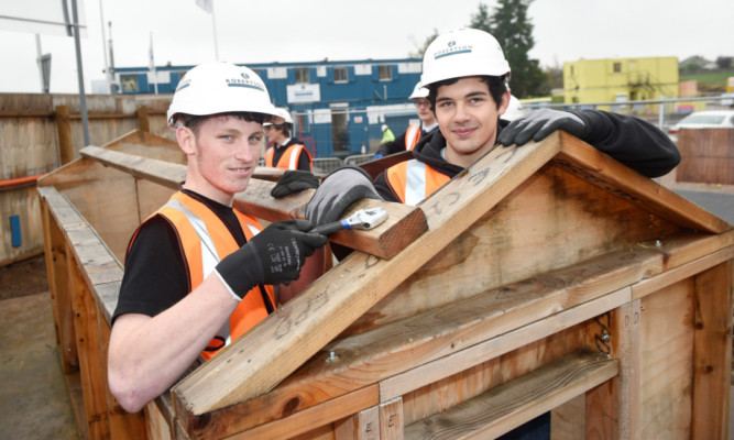 Gary McKay, left, and Steven Pryde, right, from St Pauls Academy in Dundee visited the Robertson development site of Forfar Community Campus, where they also got to test their skills with mono-blocking and joinery work.