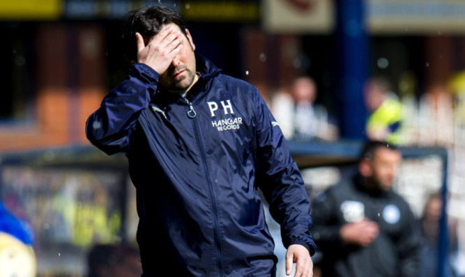 Bad day at the office? Dundee manager Paul Hartley looking dejected during a game with St Johnstone at Dens Park in April