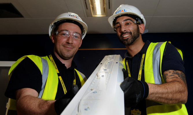 fROM LEFT: Stu Wright and Mario Varnava from Vital Energi fitting the new system at Ninewells Hospital.