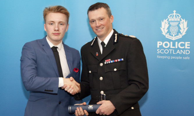 Deputy Chief Constable Neil Richardson presents Joe Lafferty with his award.