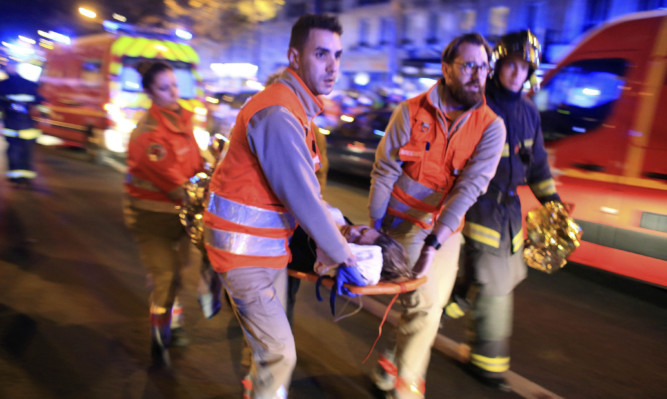 A woman is stretchered away from the Bataclan theatre after the hostage drama.