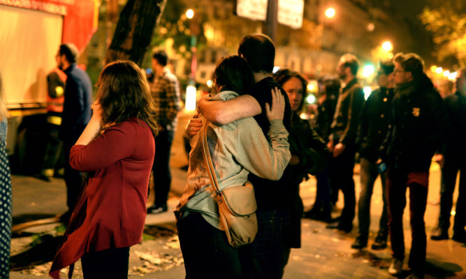 Parisians look at the scene outside the Bataclan concert hall after the attack.