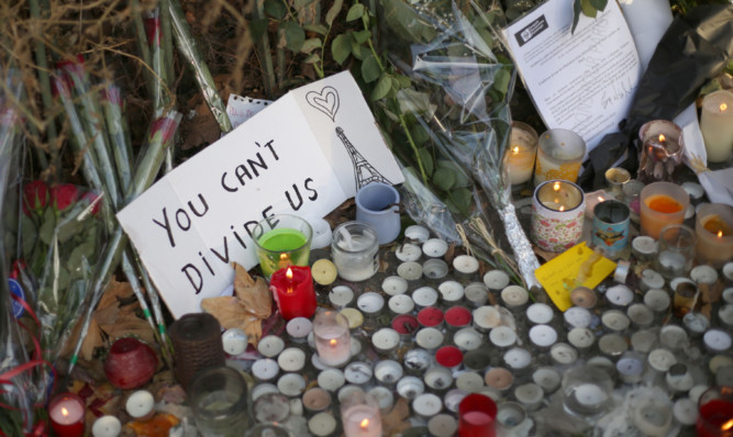 Flowers and tributes are left close to the Bataclan concert hall, Paris.