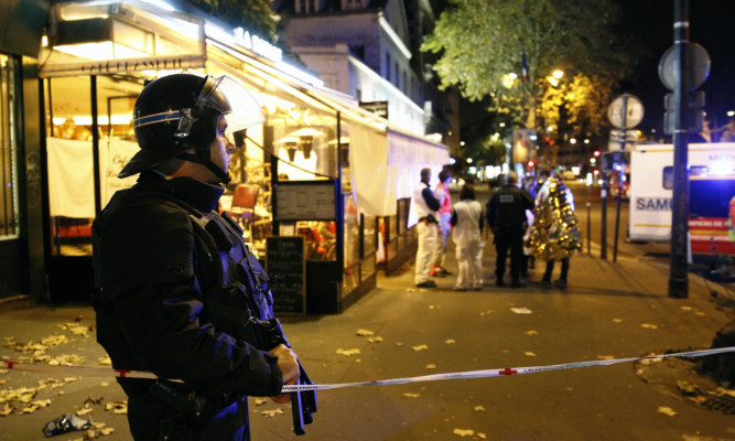A policeman on the streets of Paris after Friday night's terrorist attacks.