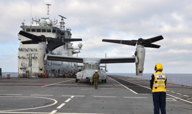 The distinctive US Marine Corps MV-22 Osprey tilt-rotor aircraft are flying off the deck of HMS Ocean during the Cougar 15 deployment, which involves marines based at Arbroath.