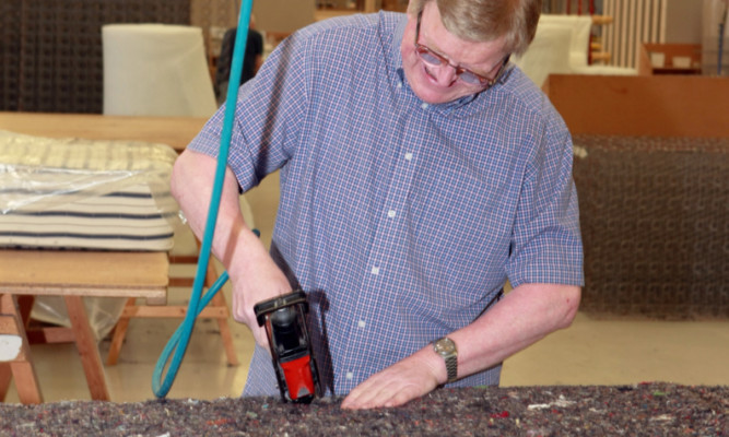 A workshop technician constructs a mattress at Dovetail Enterprises in Dundee.