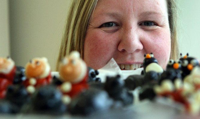 Production supervisor Michelle Stewart looking at some of the edible decorations for the ice cream cakes at Jannettas of St Andrews