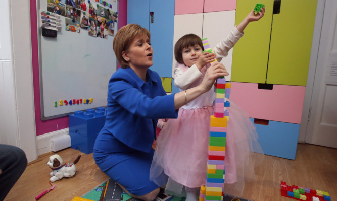 First Minister Nicola Sturgeon plays with three-year-old Miriam during a visit to Daddy Daycare in Edinburgh.