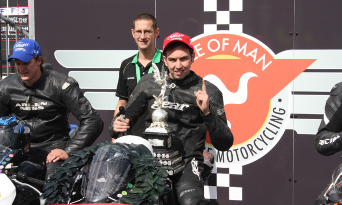Andy Lawson with the Junior Manx GP trophy in 2014.