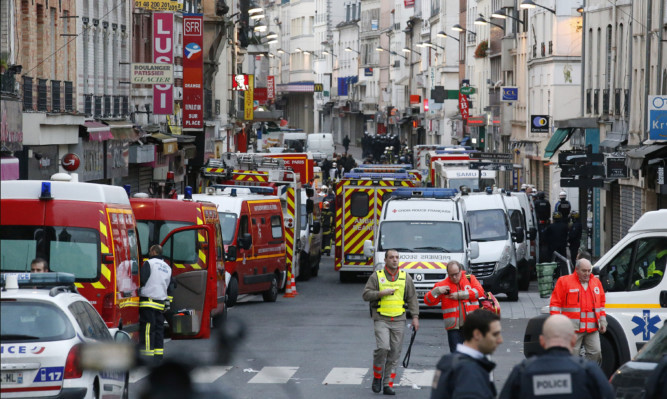 Police and Ambulance vans are parked in the Saint-Denis area of Paris  after a flat was raided by French police in the wake of the terro attacks.