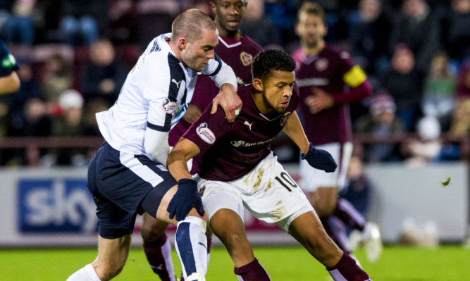 James McPake battles for the ball with Hearts' Osman Sow.