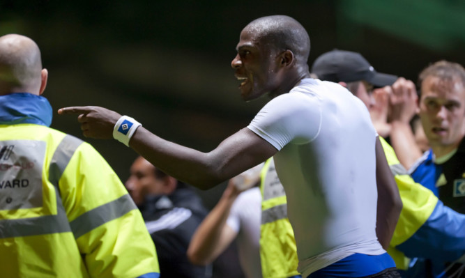 Guy Demel, then at Hamburg, shows his frustration with the Parkhead stewards during a game against Celtic.