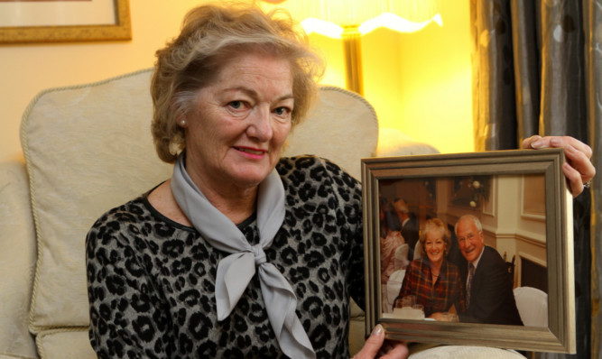 Elizabeth Birrell with a photograph of herself and her late husband Ian.