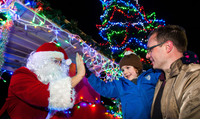 Mille Rose Garrick-Orr high-fives Santa at last years lights switch-on, alongside dad Warren Orr.