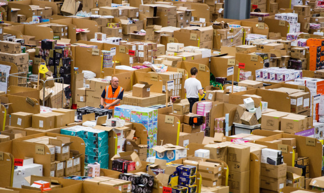 Staff at a fulfilment centre for Amazon.co.uk, which expects to have its busiest ever day on Friday.