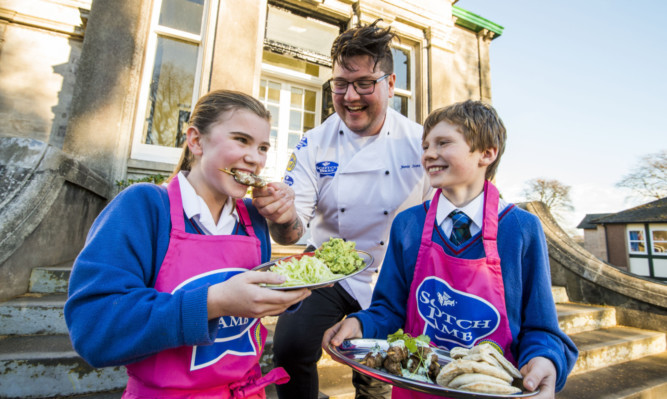 Georgina Boyd from Forgandenny and Ross Grant from Balbeggie sample the Scotch lamb koftas the pupils made with Jamie Scott in the new school kitchen classroom at Craigclowan.
