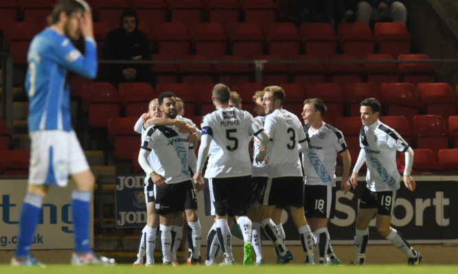 The Dundee players celebrate Kane Hemmings' goal.