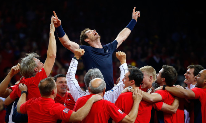 Andy Murray celebrates with his team-mates after winning his singles match to win the Davis Cup for Great Britain.