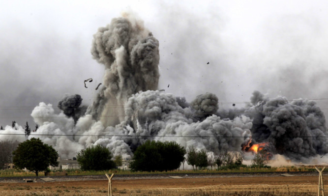 Smoke rises after an air strike on the Syrian town of Kobani late last year.