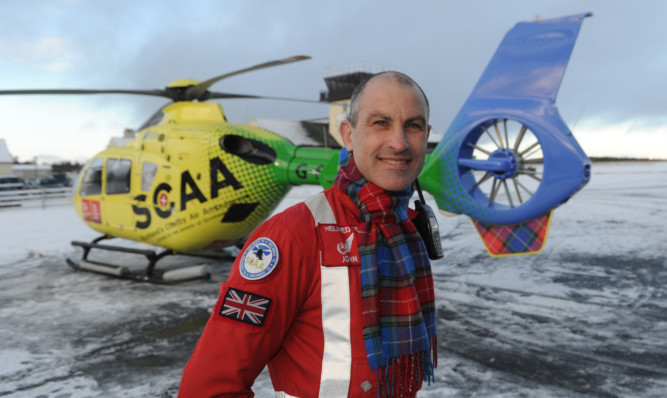 Lead paramedic John Pritchard shows off the new tartan.