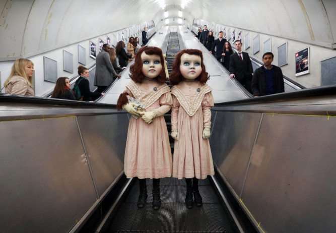 EDITORIAL USE ONLY
Two life-size Victorian style dolls shocked Londoners this morning as the creepy pair popped up at commuter hotspots across the capital to mark the launch of the worldÕs first psychological theme park ride created by Derren Brown, coming to Thorpe Park Resort in 2016. PRESS ASSOCIATION Photo. Picture date: Thursday December 3, 2015. The incredibly realistic 4ft 7Ó high Ôliving dollsÕ were played by two models who each spent over three hours being transformed by a top team of stylists, costume designers, make-up artists and dressers. The dolls were spotted at numerous venues in London including Charing Cross Tube Station, Oxford Circus, Regents Street and Hamleys where they were seen playing with a toy train set, carrying dolls and pushing an empty 1900Õs style pram. Visitors to the ÔthemedÕ experience at Thorpe Park Resort in 2016 will embark on a 13 minute journey, making the one-of-a-kind attraction a totally unique theme park experience. 
Photo credit should read: Matt Alexander/PA Wire