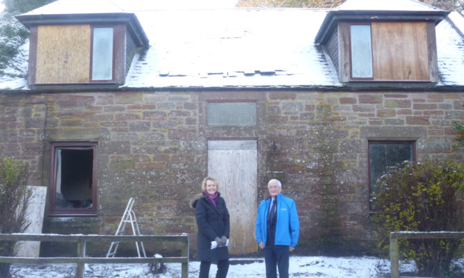 Councillor John Kellas and Isobel Butt, the council's vacant property development officer, at a property in Alyth that could be brought back into use under the scheme.