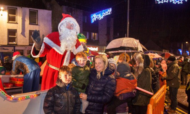 Santa joins the crowds as the Christmas lights are switched on in Forfar.