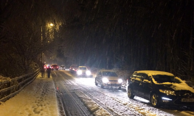 Heavy snow causes heavy traffic congestion near Penicuik in Midlothian.