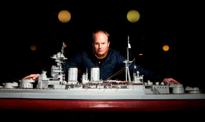 Auctioneer Nick Burns with the replica HMS Hood.