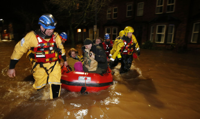 A family are rescued by the coastguard in the centre of Carlisle.