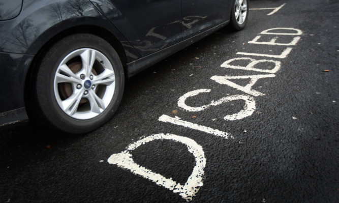 A car without a blue badge parked in a disabled bay on South Tay Street.