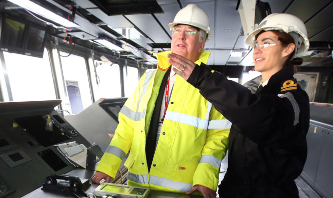 Michael Fallon talks with Royal Navy Lieutenant Rachel Campbell on the bridge of the HMS Queen Elizabeth.
