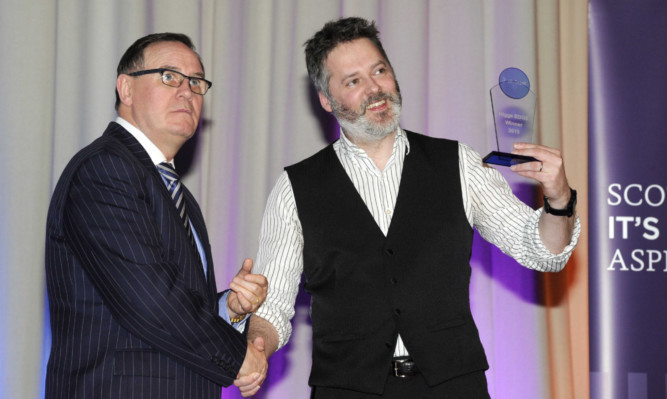 Judging panel chairman Lord Willie Haughey, left, congratulates Dr Craig Robertson.