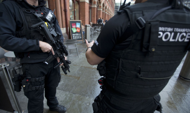 Armed police officers outside St Pancras international railway station in London, as security is stepped up.