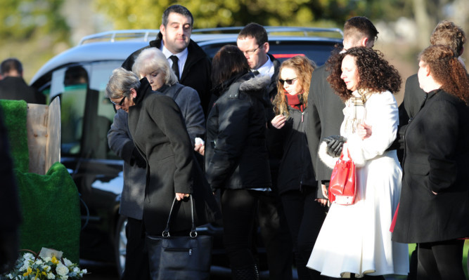 A moment of reflection at the graveside for Charmain's mother Linda Speirs (left).