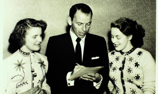 Two lucky fans get an autograph from Frank Sinatra in Dundee in 1953.