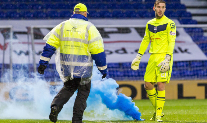 A flare was thrown on to the pitch during St Johnstone's match with Ross County.