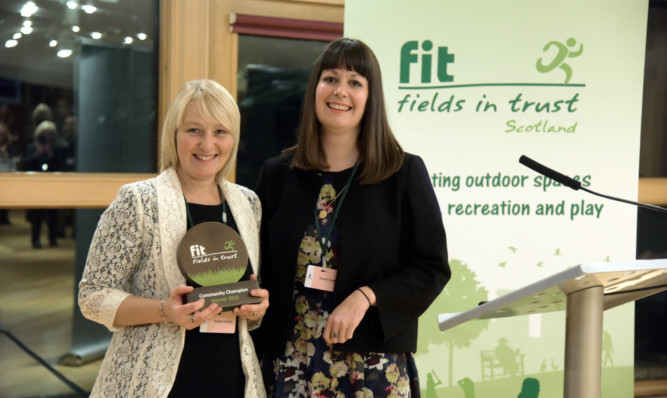 Jillian receives her award from chief executive Helen Griffiths.
