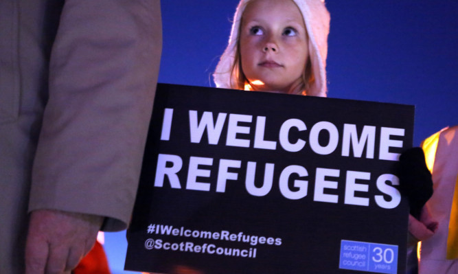A youngster at a recent event in Dundee to show support for refugees.