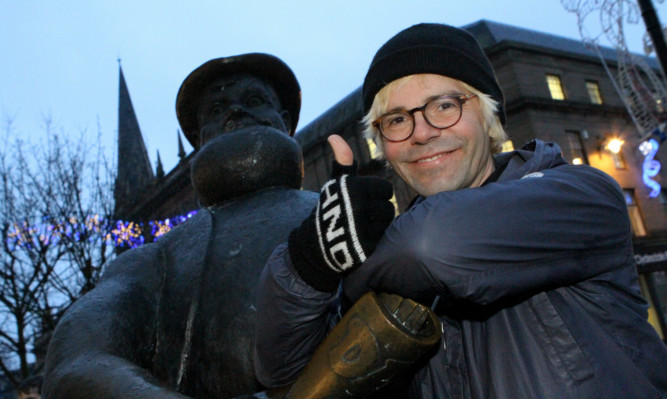 Lead singer of The Charlatans Tim Burgess poses with Desperate Dan as his band get set to play at the Caird Hall.